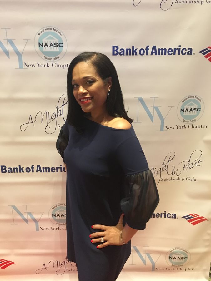 A woman posing at the NAASC New York Chapterβs A Night in Blue Scholarship Gala